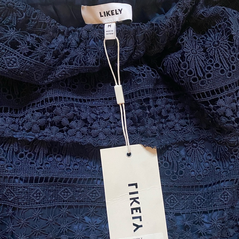 Likely off the shoulder lace top, navy.